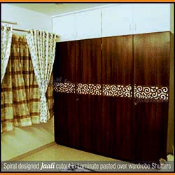 Spiral designed Jaali cutout in Laminate pasted over wardrobe Shutters